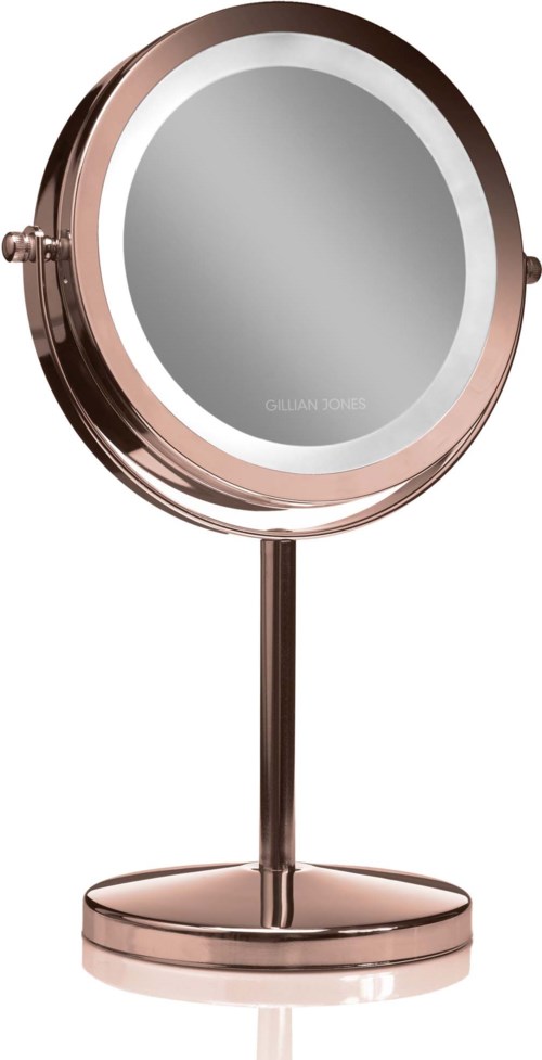 En rosegull rund speil på stativ med reflekterende glassoverflate.