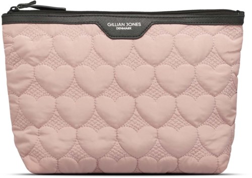 A pink quilted makeup bag with heart patterns and a black zipper at the top, labeled Gillian Jones Denmark.