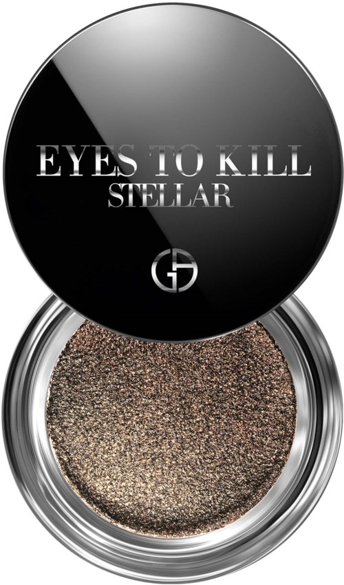 This is a cosmetic container with a dark lid displaying the words "Eyes to Kill Stellar" and a logo. The bottom shows a glittery eyeshadow.
