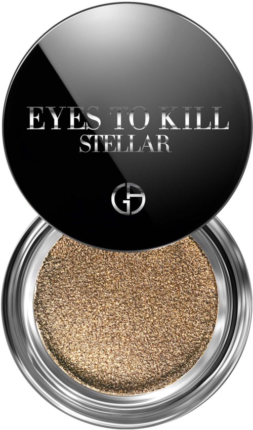 En rund behållare med guldfärgad ögonskugga och svart lock med texten "EYES TO KILL STELLAR."