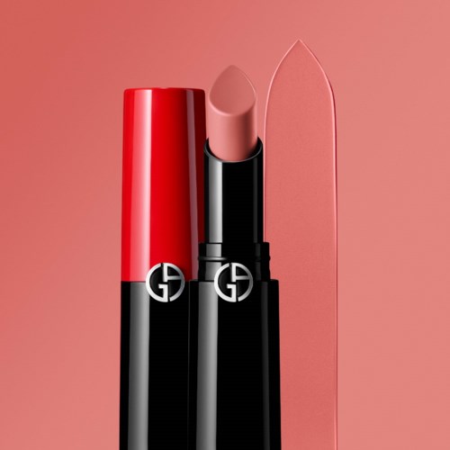 A lipstick with a black case and a red cap, and a matching pink lipstick swatch on a pink background.