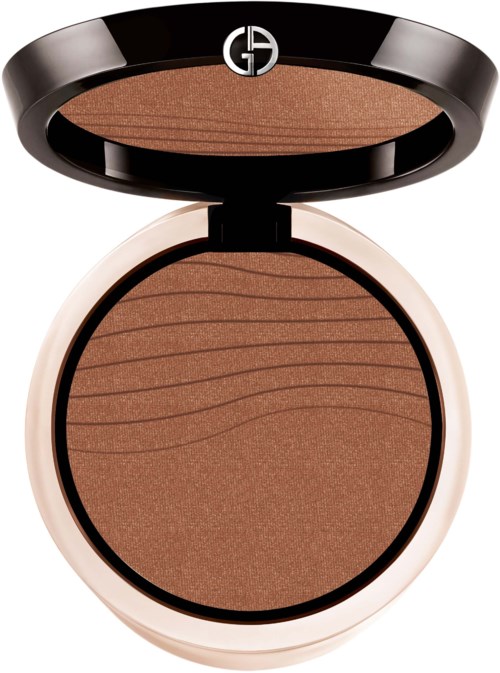 A compact with brown pressed powder inside, open lid with a black top and white bottom, round shape.