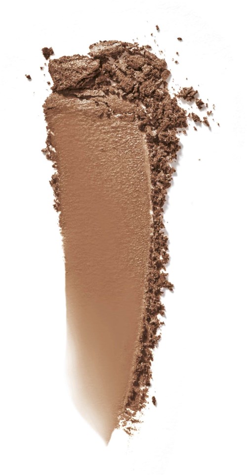 En beige kremflekk med noe pulveraktige biter rundt.