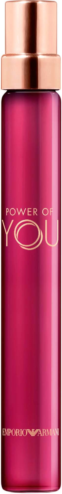A tall pink spray bottle with copper-colored cap and text, set against a black background.