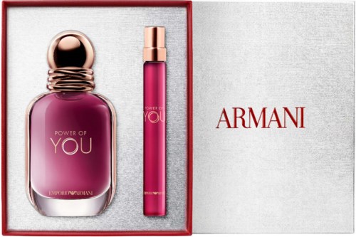 A pink perfume bottle with a gold cap and a matching pink lipstick in a red and white box with Armani branding.