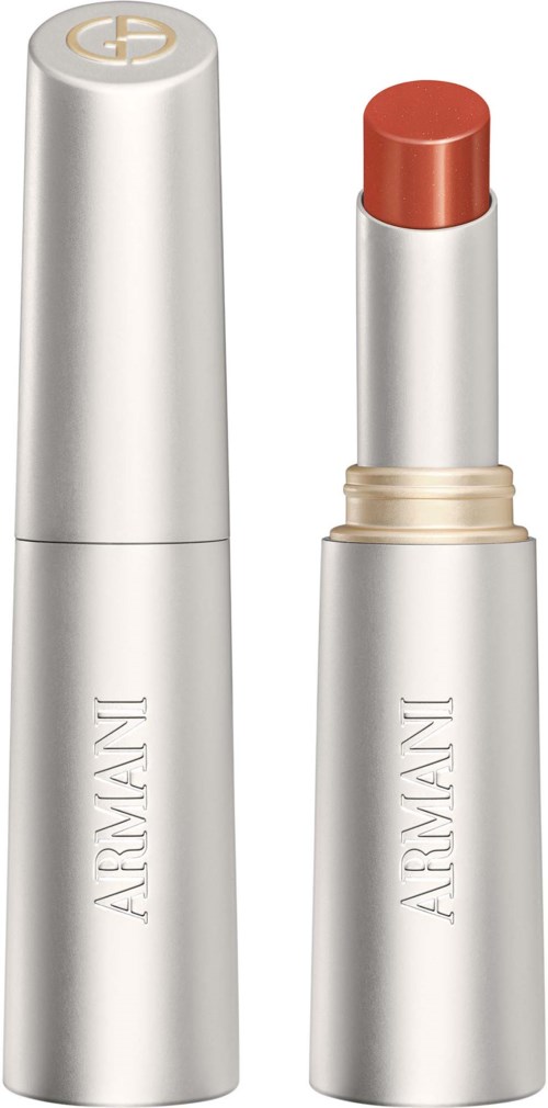 Een zilveren lippenstift met de dop eraf, die de beige lipstick binnenin toont.