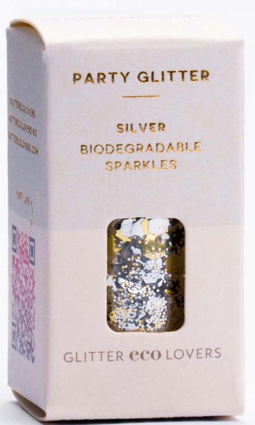 Eine weiße Packung mit goldener Schrift und transparentem Fenster, das silberne biologisch abbaubare Glitzer zeigt, beschriftet 'Party Glitter' und 'Eco Lovers.'
