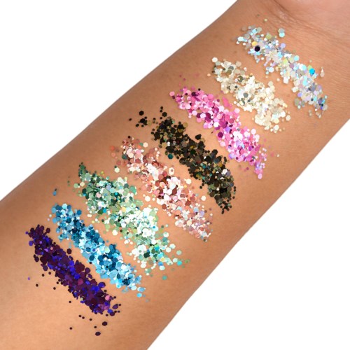 Kleurrijke glitterstalen op huid, die verschillende tinten roze, blauw, groen, zwart, beige en wit tonen.