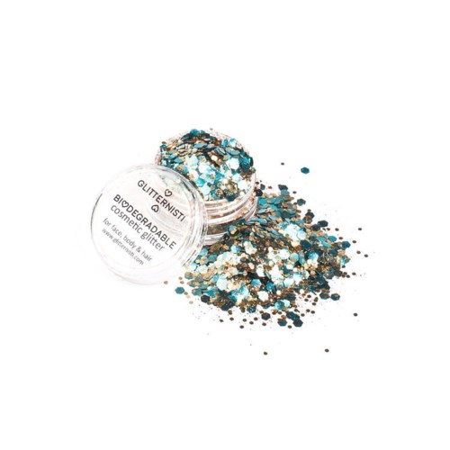 Een klein potje met glitter in blauw, goud en zilver, die is uitgegoten. Het label zegt dat het biologisch afbreekbare glitter is.