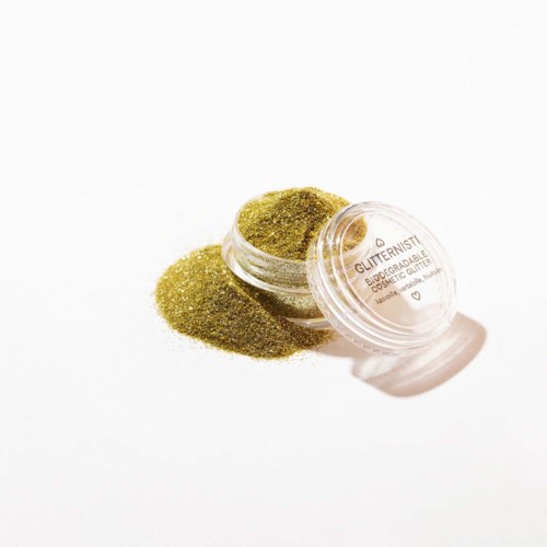 Kleine doorzichtige container met glanzende groene glitter die buiten verspreid is. Labels voor cosmetica of make-up gebruik. Heldere, eenvoudige achtergrond.