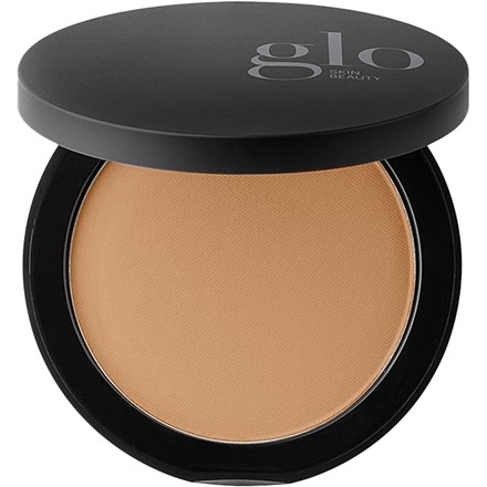 A foundation compact with a black lid and beige pressed powder inside.
