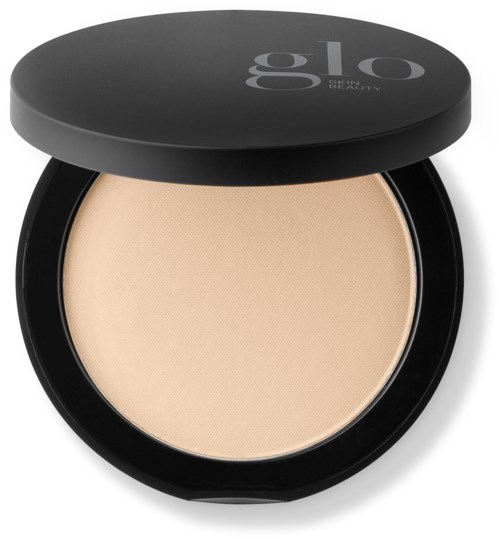 A compact powder container with beige powder inside, black lid, and the word "glo" on top.