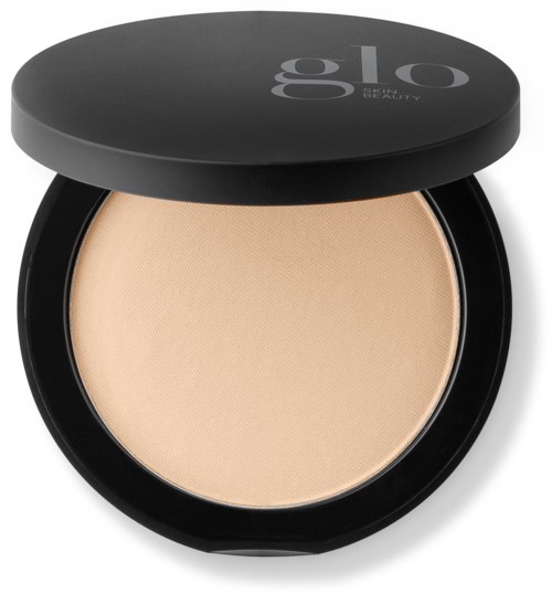 A compact makeup product with a beige powder and a black lid labeled "glo beauty."