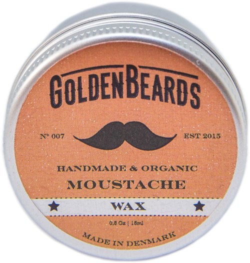Rust-colored label with black mustache and text about handmade organic mustache wax, made in Denmark.