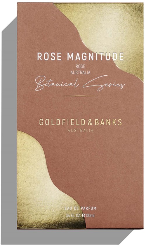En blomsterparfymförpackning i rosa och beige färger, med text om Rose Magnitude och Goldfield & Banks.