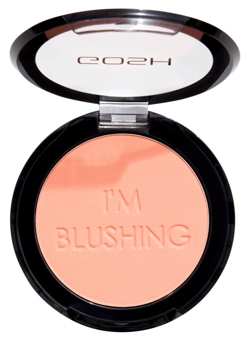 En liten dosa med puder i persiko-färg som är inpräntad med 'I'M BLUSHING' och ett spegel i locket.