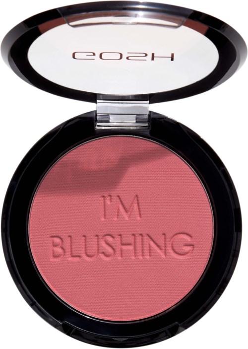 Een ronde compact met spiegel aan de bovenkant, gevuld met roze blush en de woorden 'I'M BLUSHING' embossed.