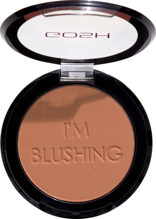 En liten kosmetikprodukt med spegel, fylld med persikofärgad blush, präglad med "I'M BLUSHING."