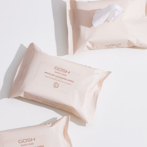 Two packets of GOSH skin care micellar cleansing wipes on a white surface with shadows. One packet is open, the other closed.