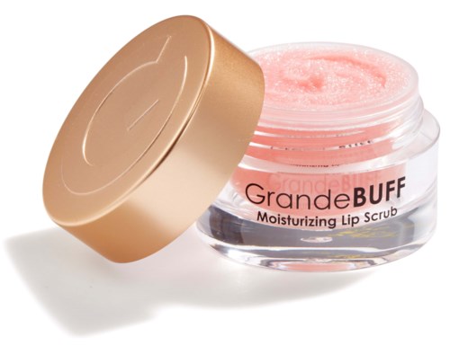 Een kleine ronde pot met roze lip scrub en een gouden deksel ernaast.