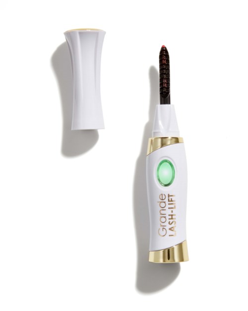 Een klein apparaatje met een draad en een groen lichtknop, gemarkeerd 'Grande Lash-Lift', gebruikt voor wimperversterking.