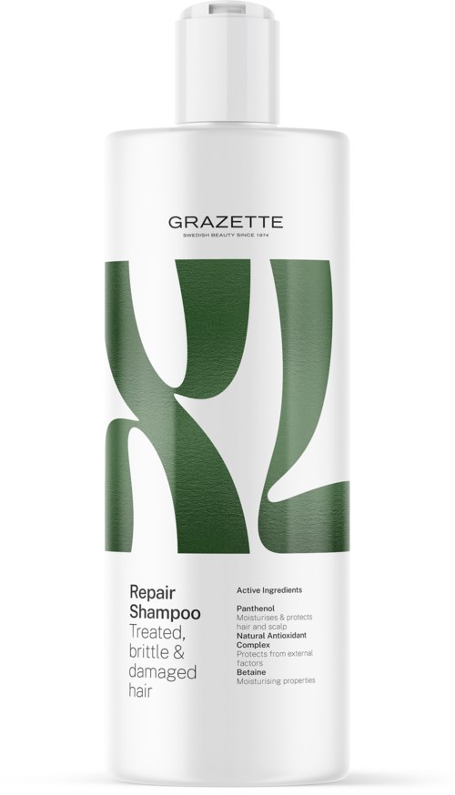 Een witte fles met grote groene letters en tekst, aangeduid als herstelshampoo voor beschadigd haar.