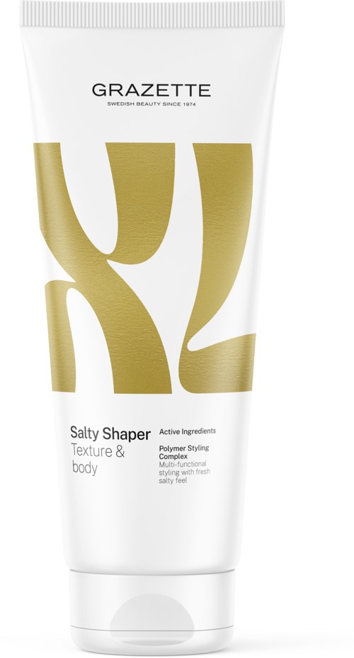 Een witte tube met gouden en zwarte tekst, gelabeld als GRAZETTE Salty Shaper voor lichaamsvorming en textuur.