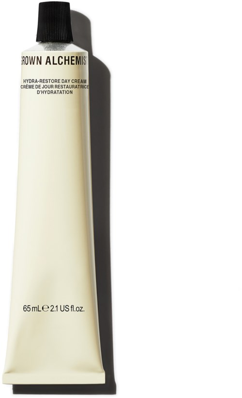 Een tube van Brown Alchemy Hydra-Restore Day Cream met een zwarte dop en witte tube.