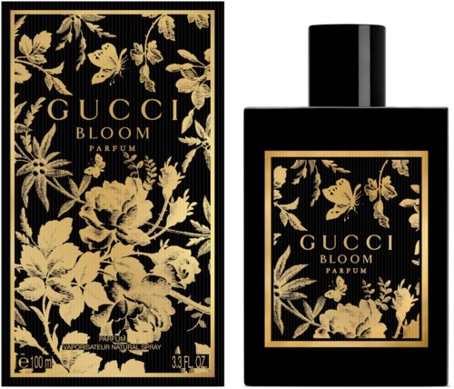 Een zwarte parfumfles en doos met gouden bloemen en vlinders, gemarkeerd 'Gucci Bloom Parfum'.