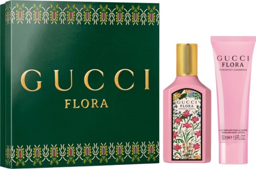 Gucci Flora perfume gift set with pink bottle and floral label, includes body lotion in pink tube and decorative box.