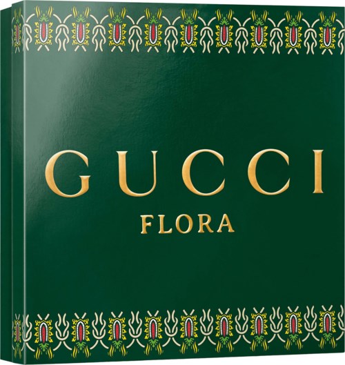 The Gucci Flora perfume box with green background and gold text, decorated with colorful floral patterns at the top and bottom.
