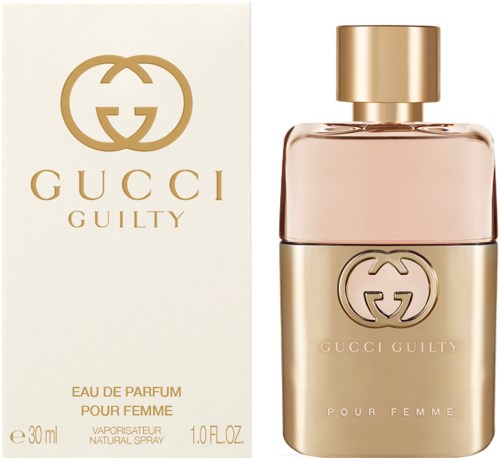 Een parfumfles en doos in goud- en beige kleuren, Gucci-logo, en de woorden "Guilty" en "For Woman."