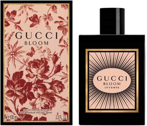 Gucci Bloom parfumdoos heeft bloemenpatroon, fles is zwart met roze label en stralende lijnen.