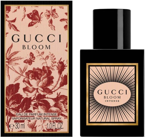 Een zwarte parfumfles met een etiket met een zonnestralenpatroon en de woorden 'GUCCI BLOOM INTENSE'.