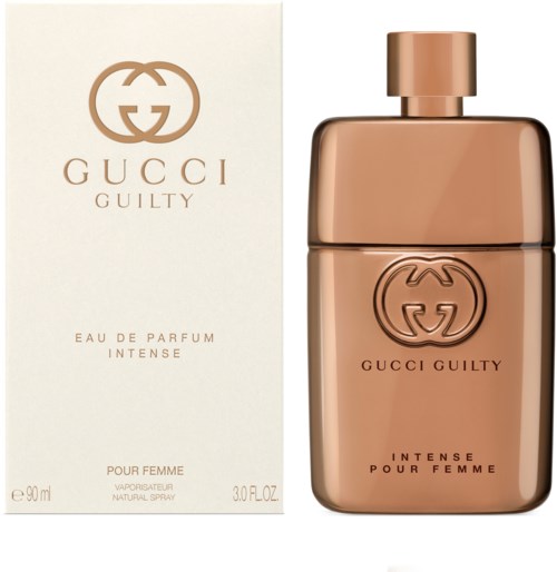 Een Gucci Guilty parfumfles en doos, met een goudkleurige glazen fles en elegante witte verpakking.