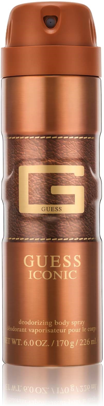 Een koperen gekleurde spuitbus met het GUESS-logo, gelabeled als "Iconic" deodorizer lichaams spray, 170 g.