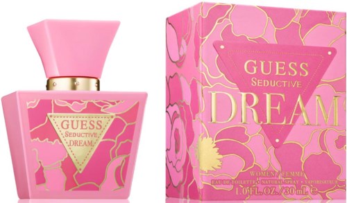 Een roze parfumfles en doos met gouden en roze bloemenpatronen, gelabeld "GUESS SEDUCTIVE DREAM" voor vrouwen.