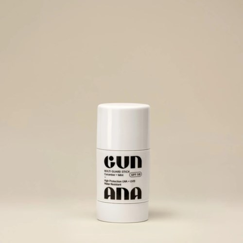 Een witte stickvormige container met zwarte tekst, gelabeld als zonnebrand spray, SPF 50. Minimalistisch ontwerp.