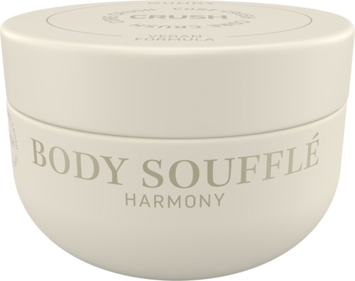 A white round container with the words "BODY SOUFFLÉ HARMONY" on it.