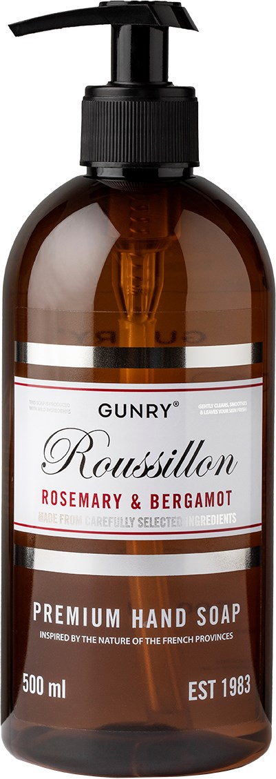 Een bruin flesje met een zwarte pomp, gelabeld als premium handzeep met rozemarijn en bergamot, 500 ml.