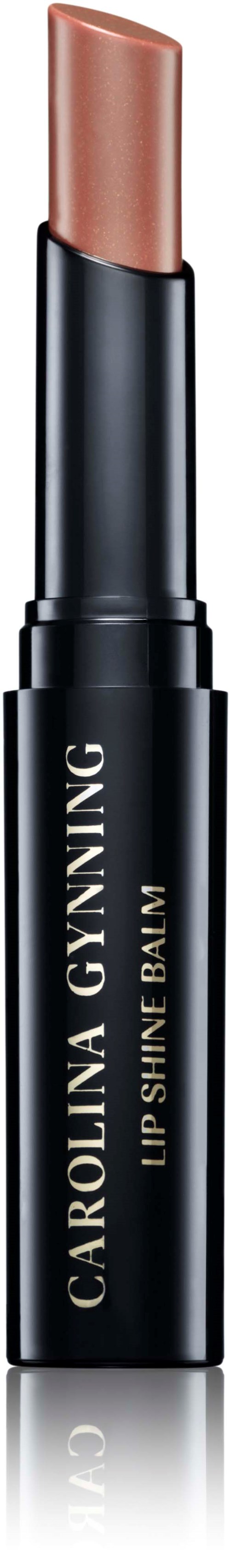 Ein Lippenstiftstift in einem schwarzen Tube mit dem Namen 'Carolina Gynning' und 'Lip Shine Balm'.