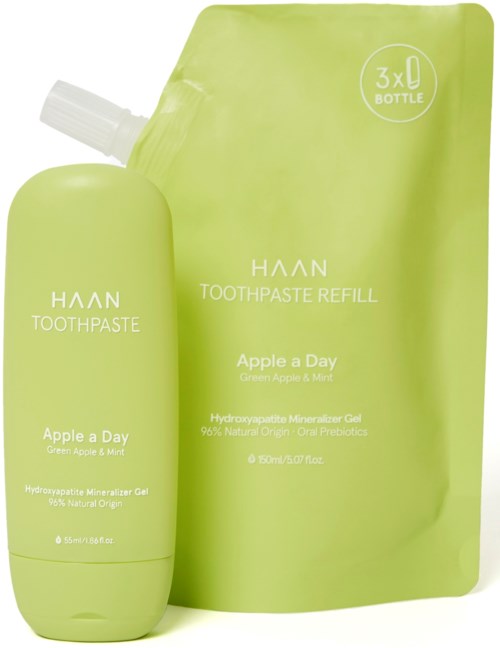 Eine grüne Zahnpasta-Flasche und Nachfüllpackung mit scanbarer Etikette, Markenname HAN, Geschmack Apple a Day.