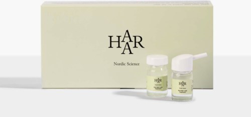 A skincare set with two bottles in front of a light box labeled 'HÅR Nordic Science.'