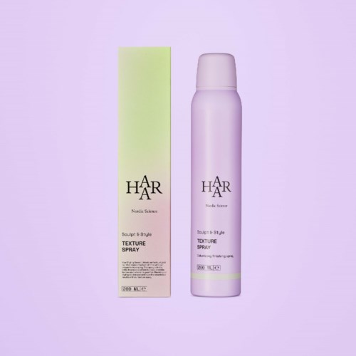 A light purple spray bottle and a green box labeled 'Textile Spray' by Haar Nordic Science.