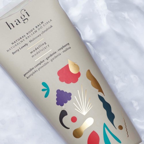 A white bottle with colorful abstract shapes and text about a natural body balm and ingredients.