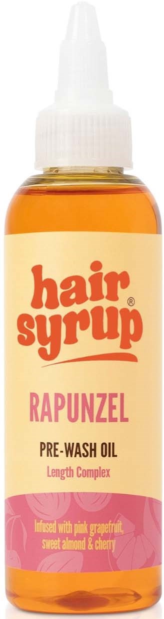 A small bottle of hair serum called Rapunzel, used before washing, with orange liquid and a pump top.