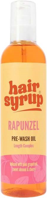 Een fles haarserum met oranje vloeistof, gelabeld Rapunzel pre-wash oil, roze en gele ontwerp, en een doorzichtige pomp.
