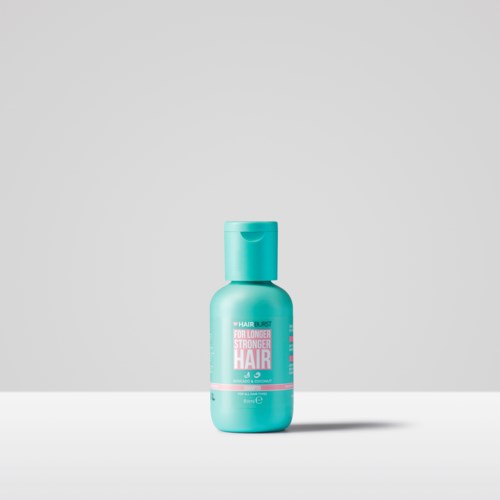 Kleine turkooiskleurige fles met haarverzorgingsproduct met roze en witte label, alleen op een eenvoudige achtergrond.