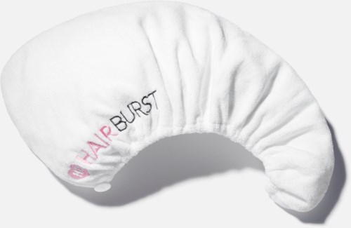 Een witte slaapmasker met roze en zwarte tekst "NAIR BURST" en een logo, gevormd om de ogen te bedekken.