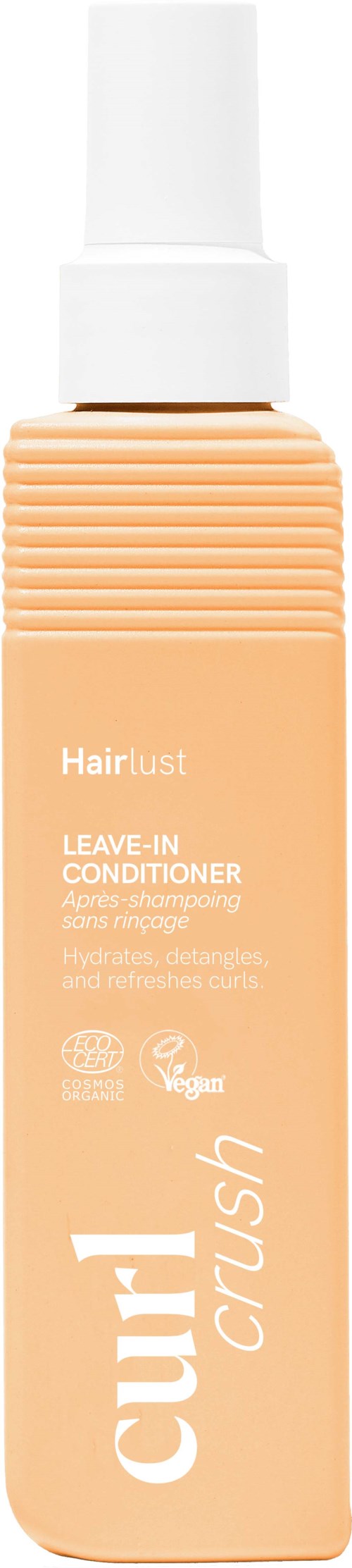 En ferskenfarget flaske av Hairlust Crush leave-in balsam med hvit sprayhette.